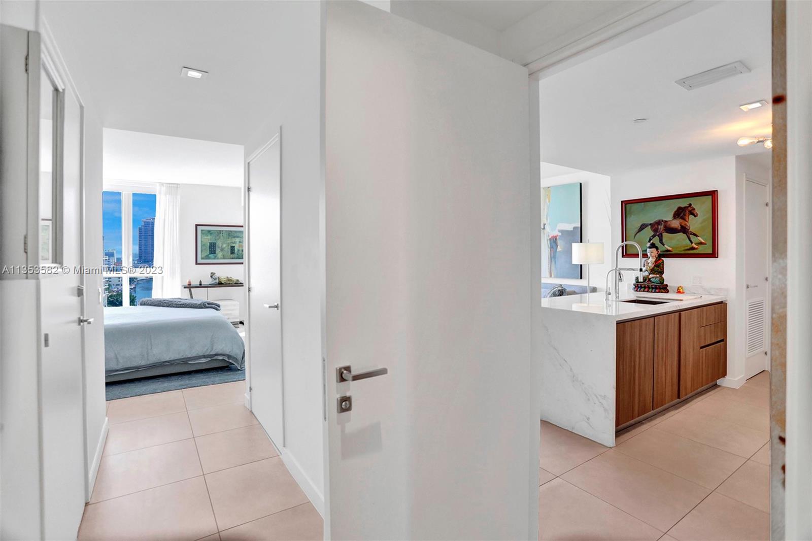 401 North Birch Road, Unit 903 Fort Lauderdale, FL 33304 - Photo 22 of 42 a en suite bathroom with a double vanity sink and a mirror