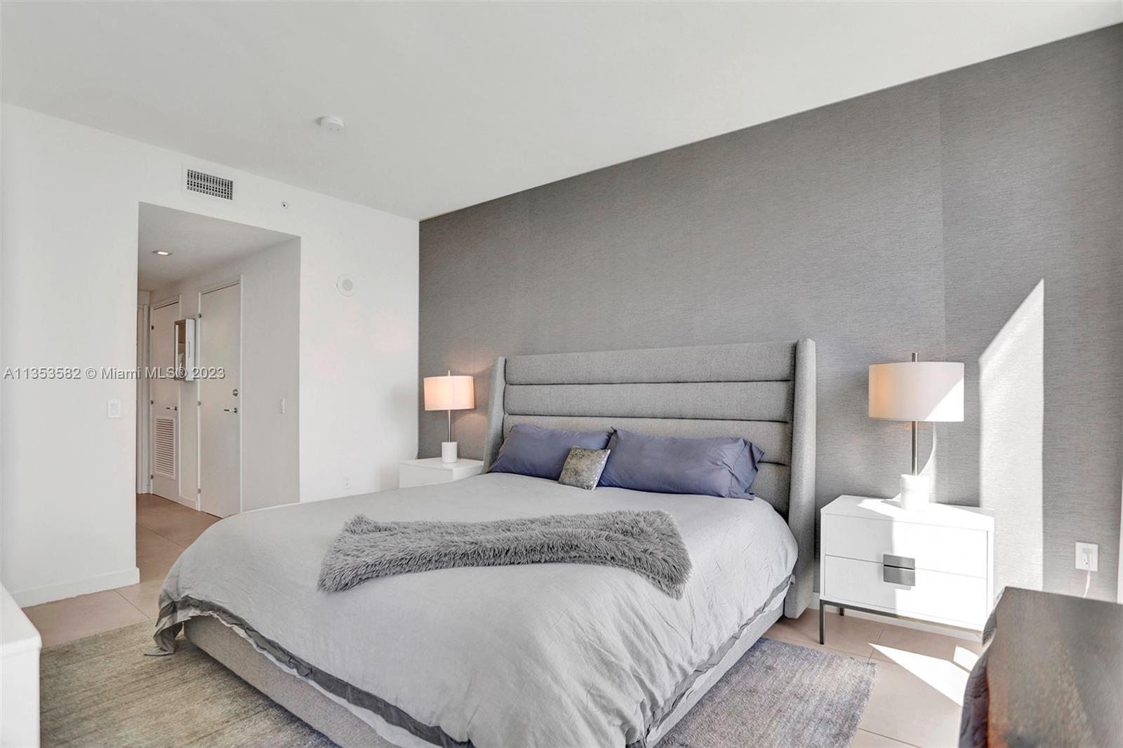 401 North Birch Road, Unit 903 Fort Lauderdale, FL 33304 - Photo 25 of 42 a bedroom with a bed and a lamp