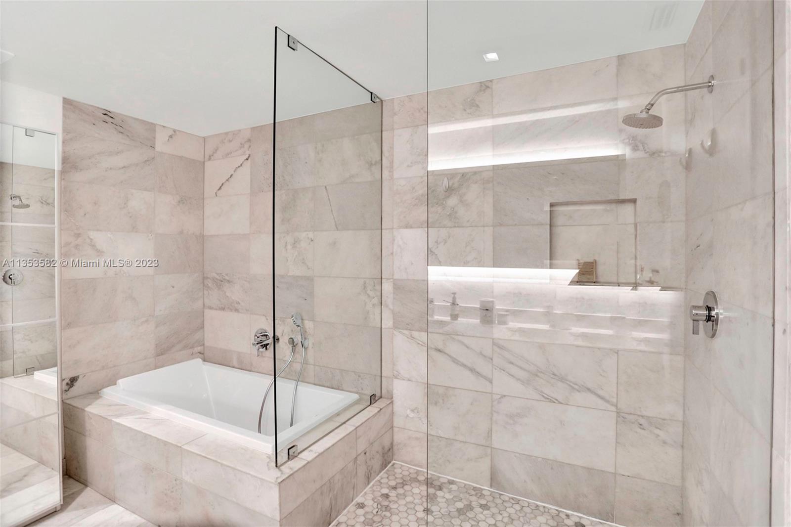 401 North Birch Road, Unit 903 Fort Lauderdale, FL 33304 - Photo 28 of 42 a bathroom with a bathtub and a shower