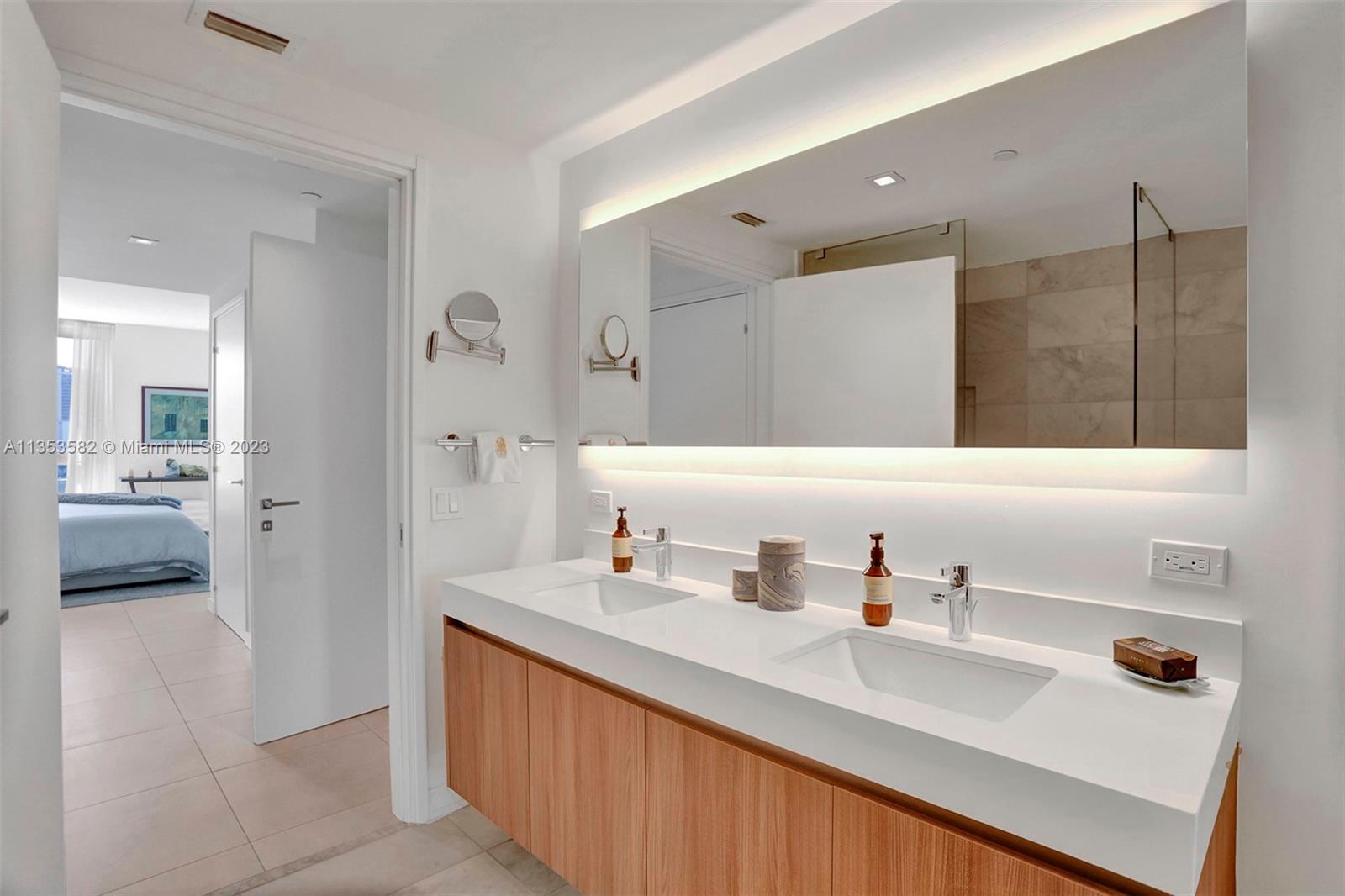 401 North Birch Road, Unit 903 Fort Lauderdale, FL 33304 - Photo 29 of 42 a en suite bathroom with a sink and a mirror