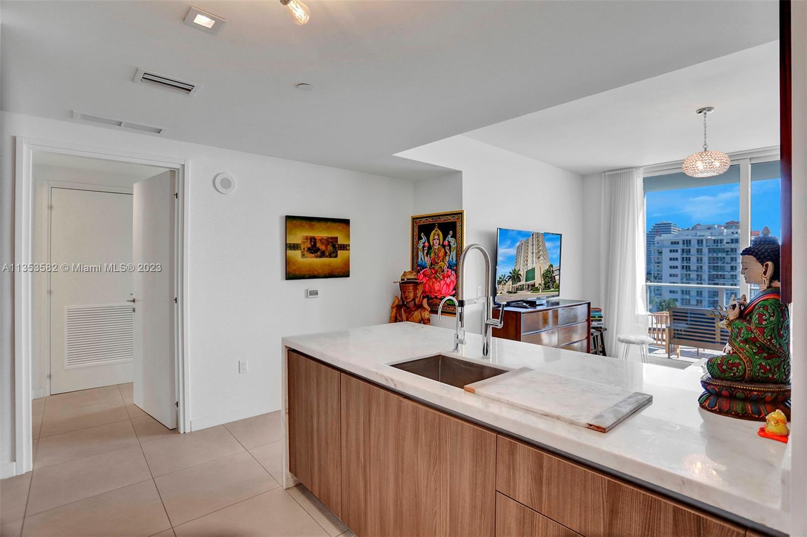 401 North Birch Road, Unit 903 Fort Lauderdale, FL 33304 - Photo 5 of 42 a view of kitchen island a sink and a refrigerator