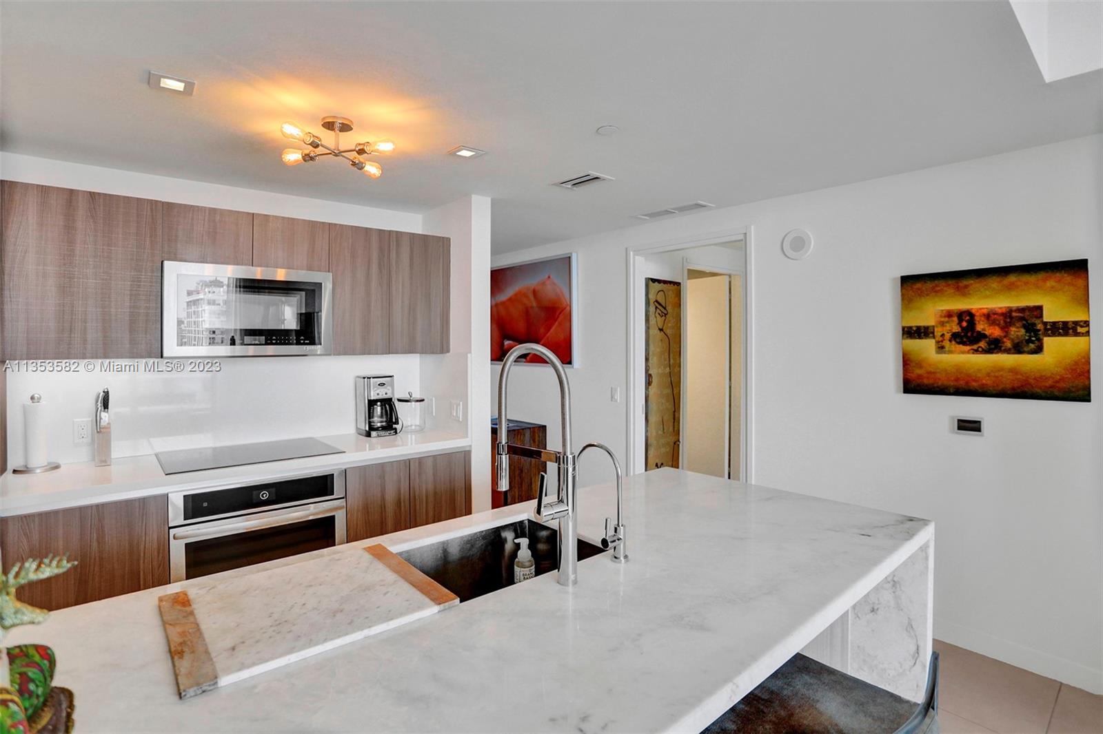 401 North Birch Road, Unit 903 Fort Lauderdale, FL 33304 - Photo 7 of 42 a room with furniture and a flat screen tv