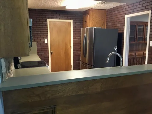 a view of a refrigerator in the kitchen
