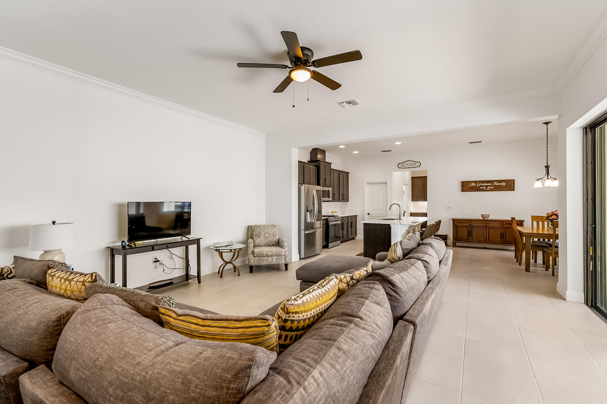 2342 Addison Drive Melbourne, FL 32940 - Photo 17 of 69 a living room with furniture and a flat screen tv with wooden floor