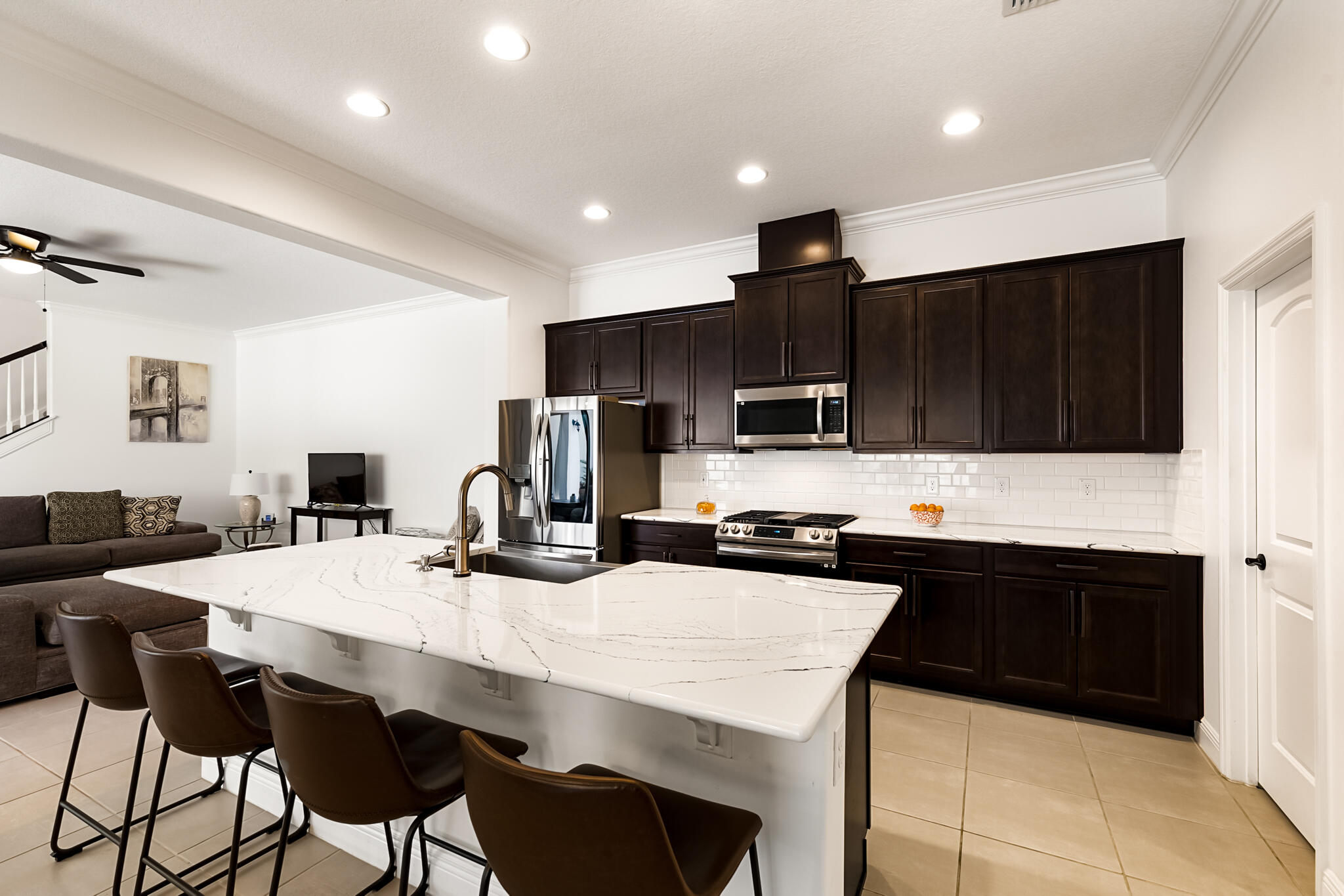 2342 Addison Drive Melbourne, FL 32940 - Photo 38 of 69 a kitchen with stainless steel appliances a stove a sink a microwave a refrigerator and cabinets