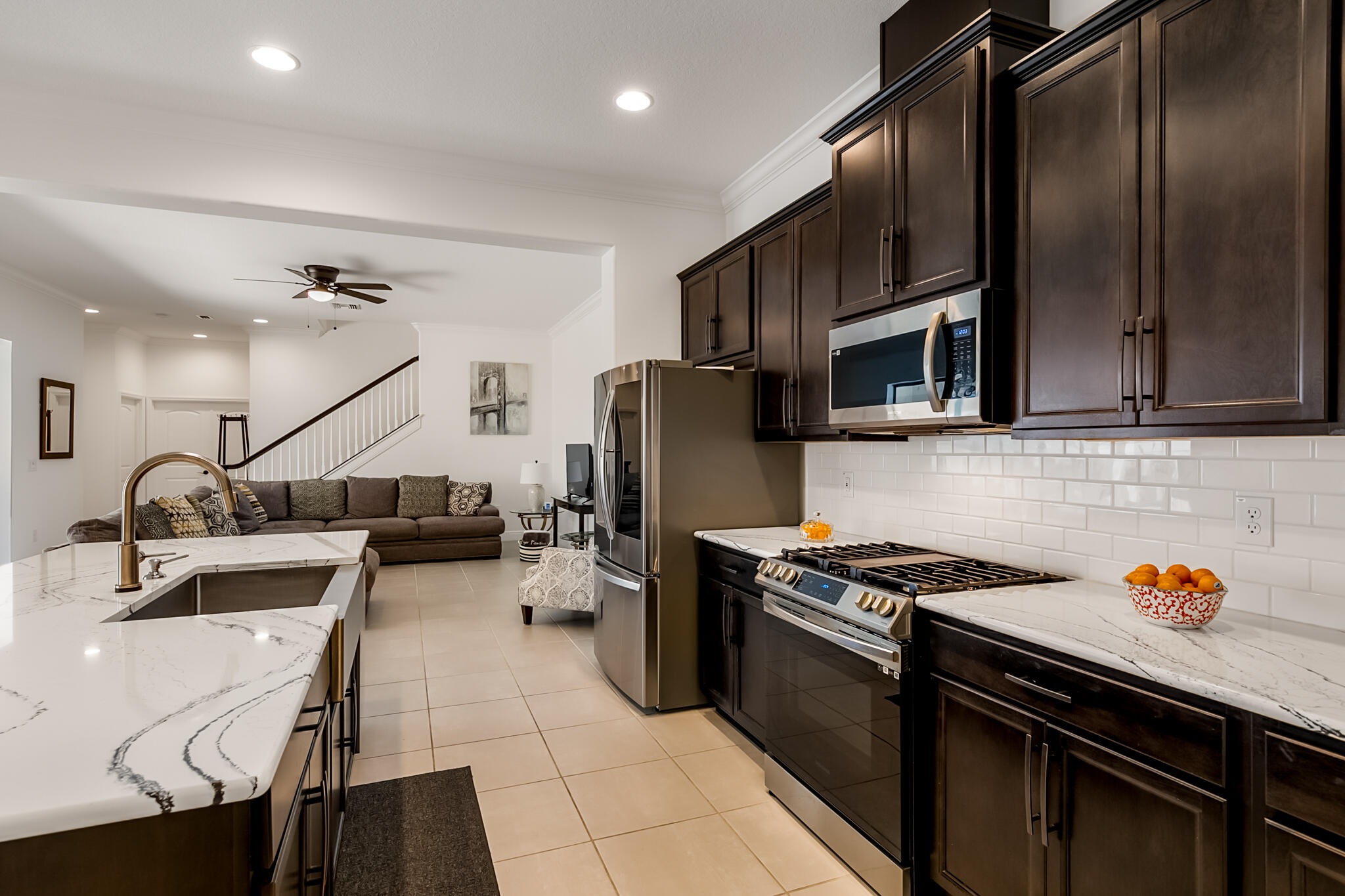 2342 Addison Drive Melbourne, FL 32940 - Photo 43 of 69 a kitchen with kitchen island granite countertop a sink appliances and cabinets