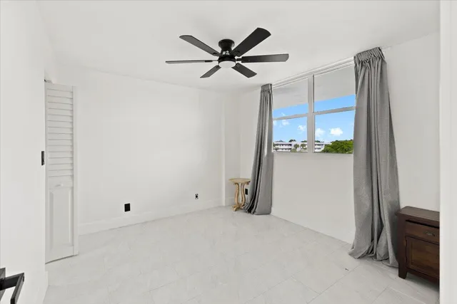 a kitchen with stainless steel appliances a refrigerator a sink a stove and white cabinets