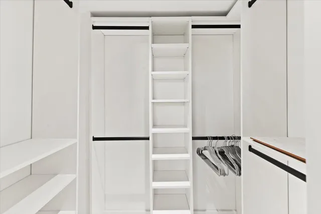 a view of empty room with ceiling fan