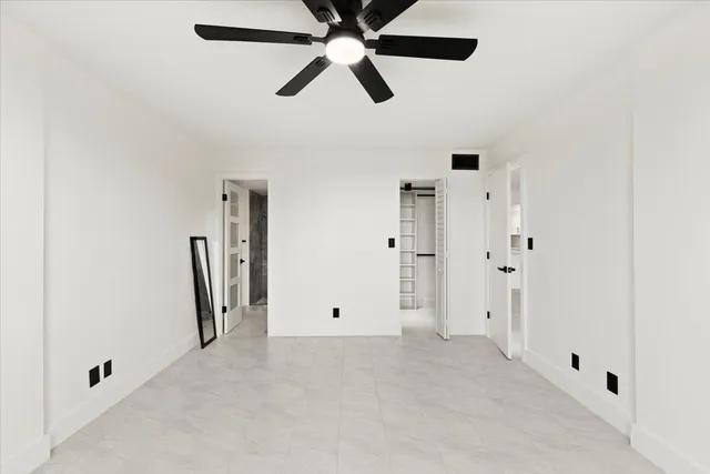 a view of room with a ceiling fan