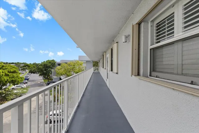 a view of a swimming pool with an outdoor seating and a pathway