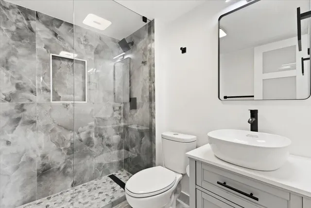 a kitchen with kitchen island a sink stainless steel appliances and cabinets