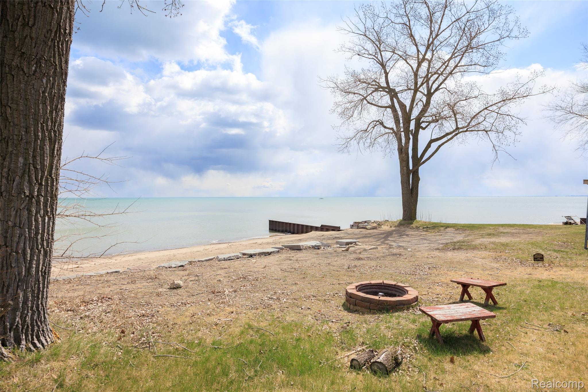 8171 Lakeshore Road Lexington, MI 48450 - Photo 32 of 45 View of yard featuring a fire pit and a water view