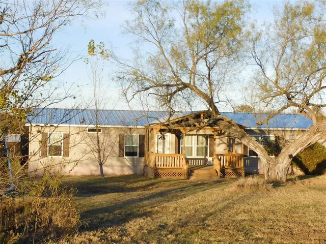 a kitchen with a stove a sink a refrigerator and wooden floor