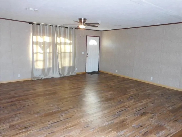 a bathroom with a granite countertop sink a toilet and a mirror