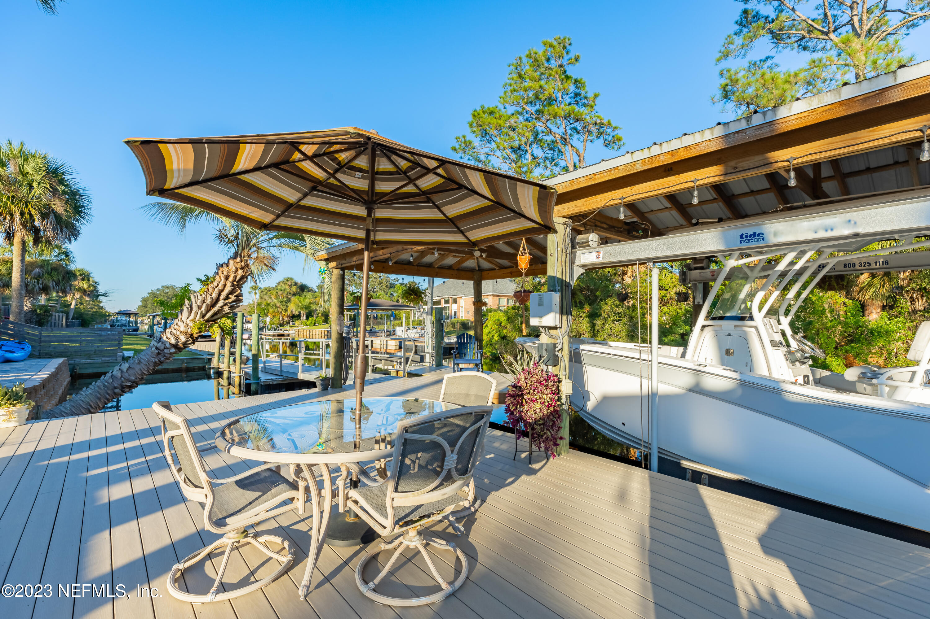 3467 Eunice Road Jacksonville, FL 32250 - Photo 14 of 83 a view of a patio with table and chairs potted plants with wooden floor