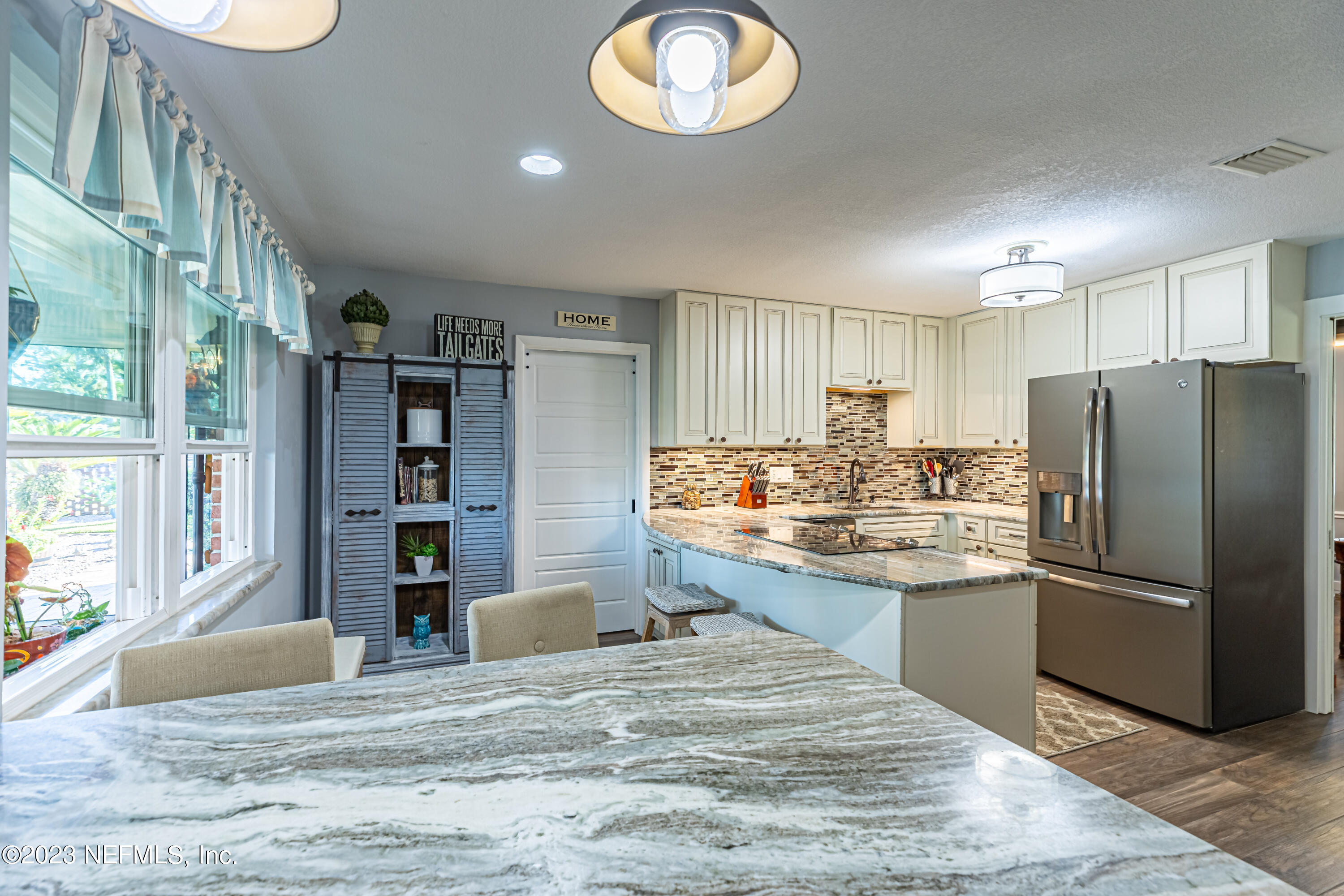 3467 Eunice Road Jacksonville, FL 32250 - Photo 32 of 83 a kitchen with stainless steel appliances granite countertop a refrigerator and a stove top oven
