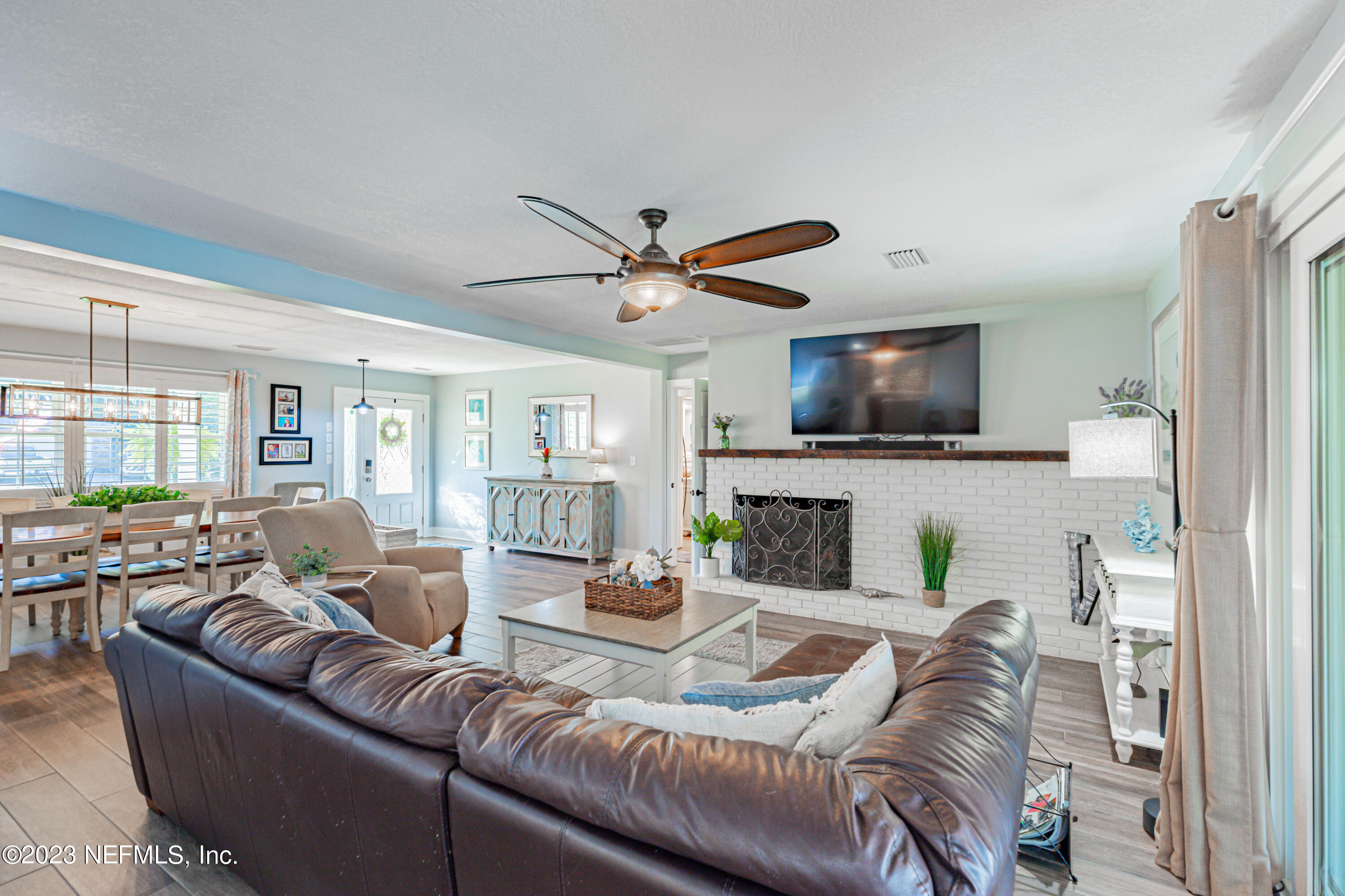 3467 Eunice Road Jacksonville, FL 32250 - Photo 36 of 83 a living room with furniture a fireplace and a flat screen tv