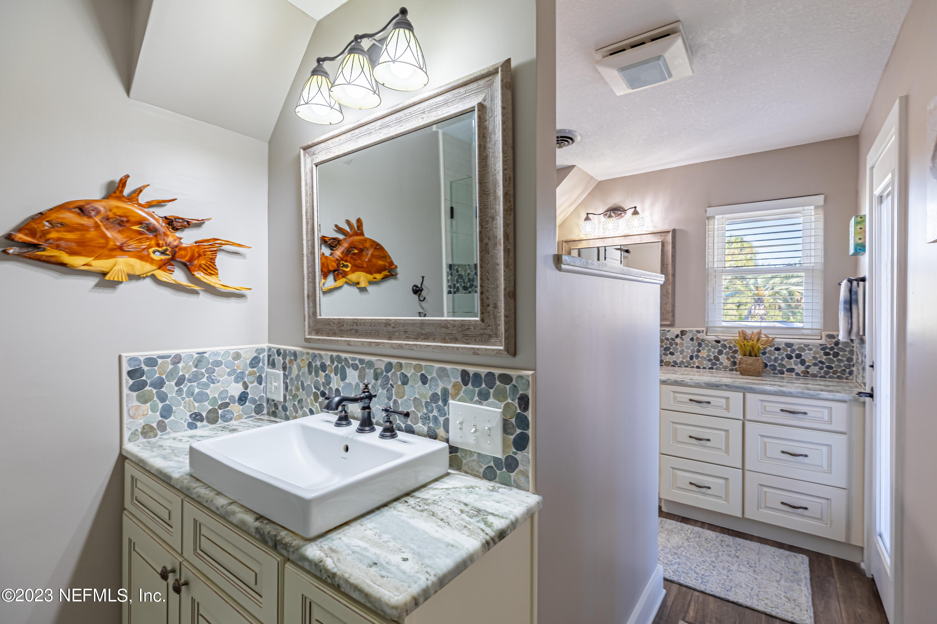 3467 Eunice Road Jacksonville, FL 32250 - Photo 47 of 83 a bathroom with a sink vanity and a mirror