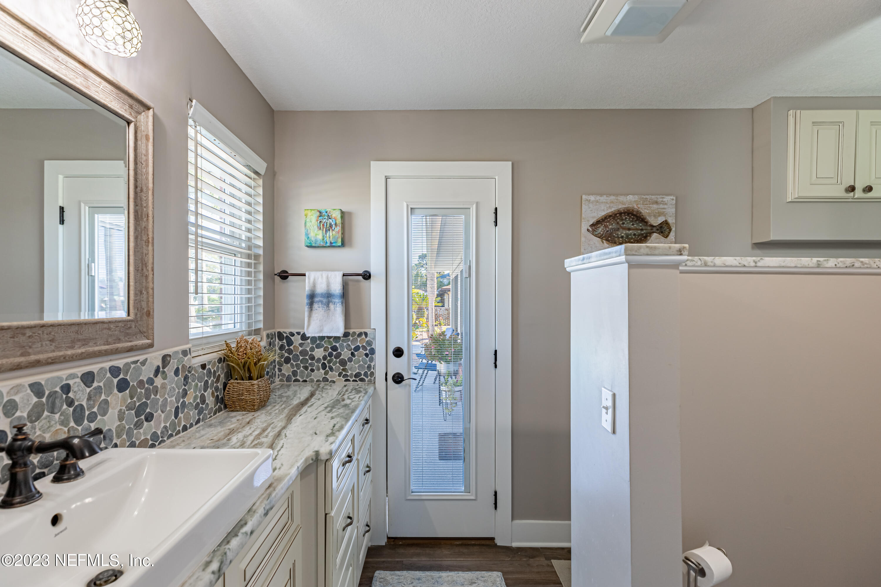 3467 Eunice Road Jacksonville, FL 32250 - Photo 49 of 83 a spacious bathroom with a tub sink and mirror
