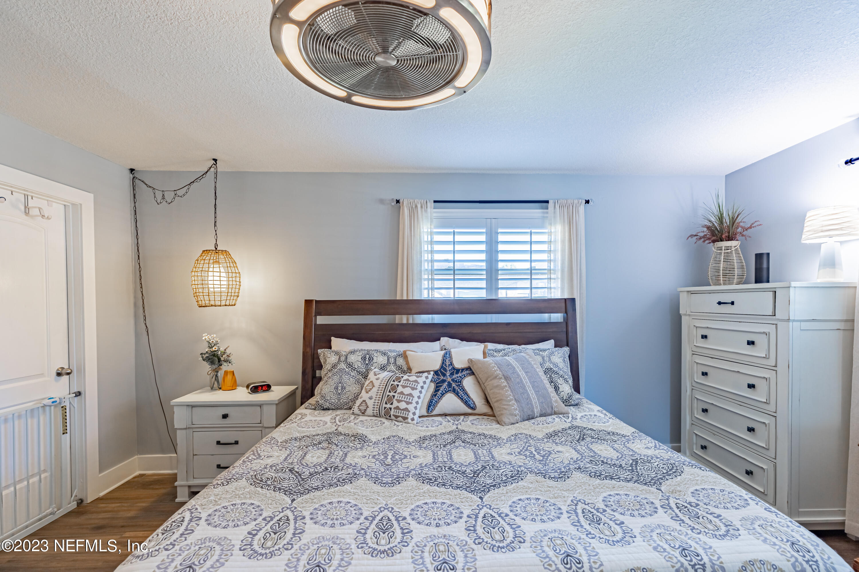 3467 Eunice Road Jacksonville, FL 32250 - Photo 50 of 83 a bedroom with a bed and a chandelier