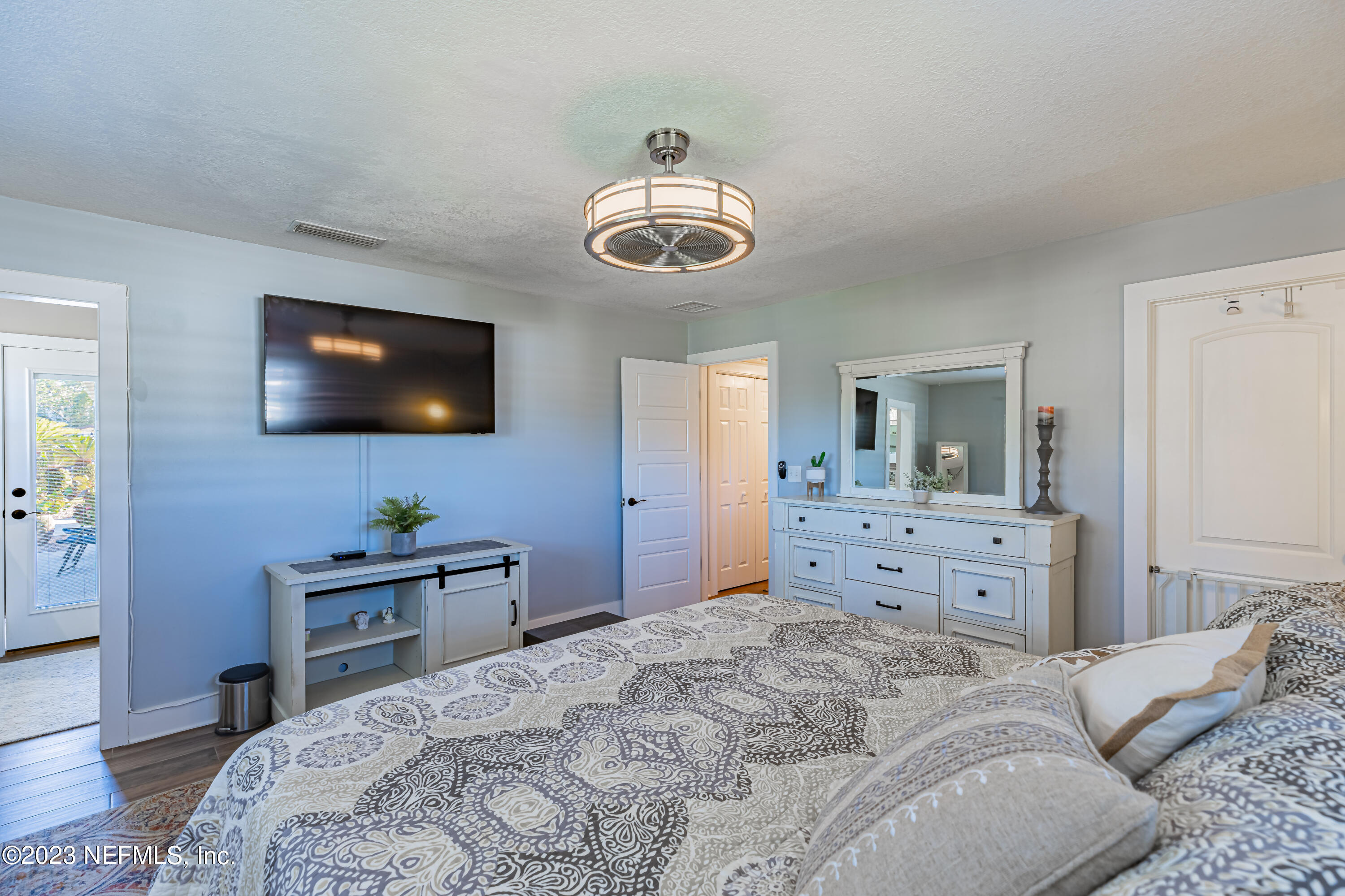 3467 Eunice Road Jacksonville, FL 32250 - Photo 53 of 83 a bedroom with a bed and wooden floor