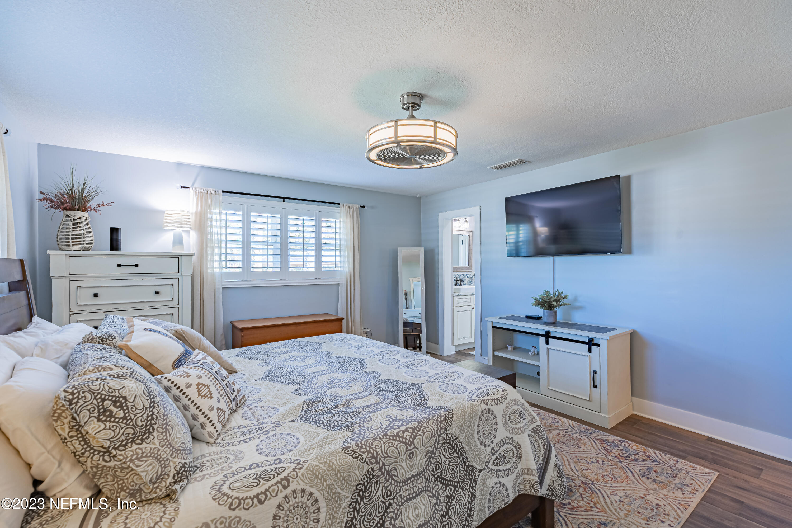 3467 Eunice Road Jacksonville, FL 32250 - Photo 54 of 83 a bedroom with a bed and a television