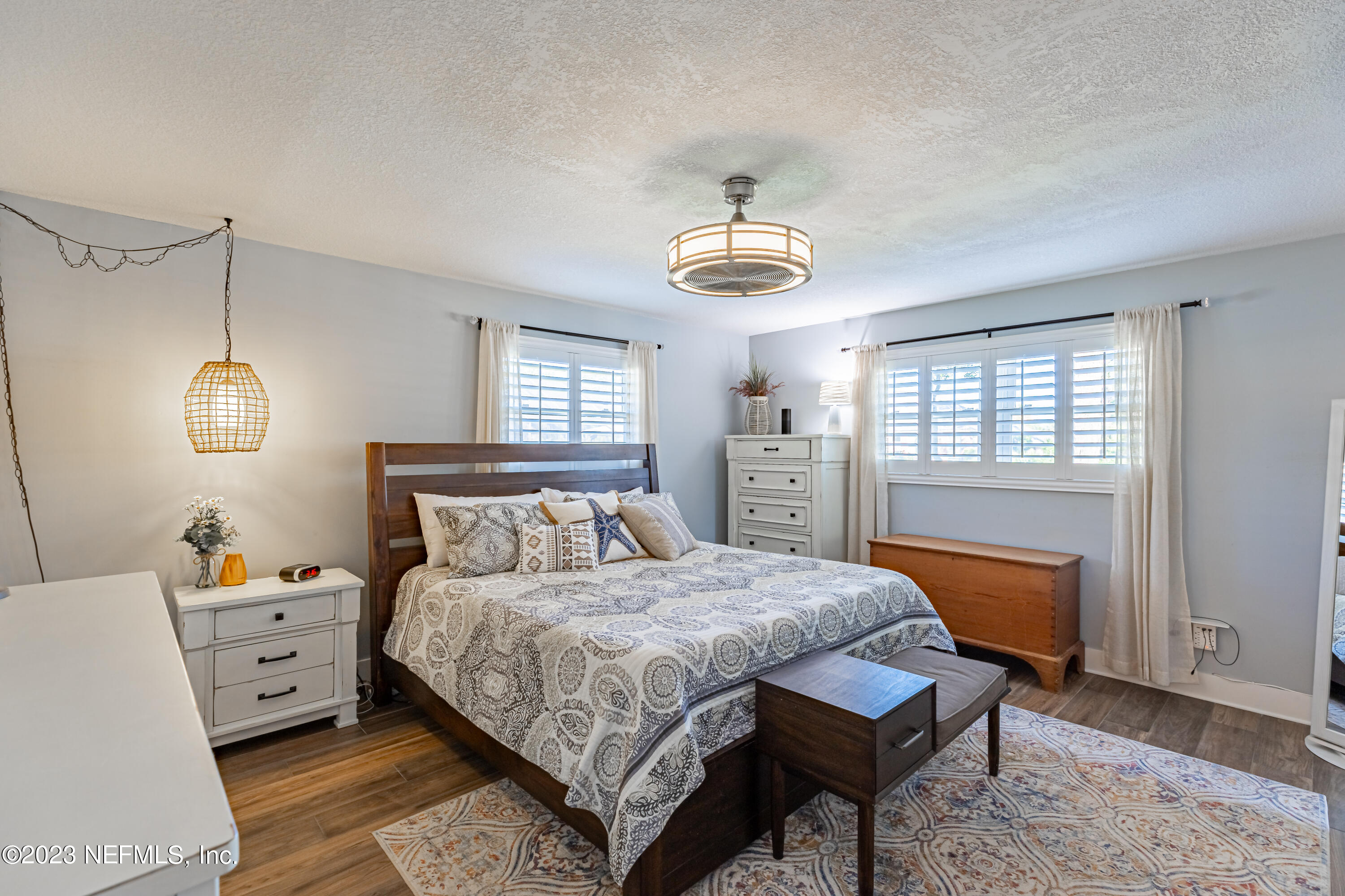 3467 Eunice Road Jacksonville, FL 32250 - Photo 55 of 83 a bedroom with a bed and wooden floor