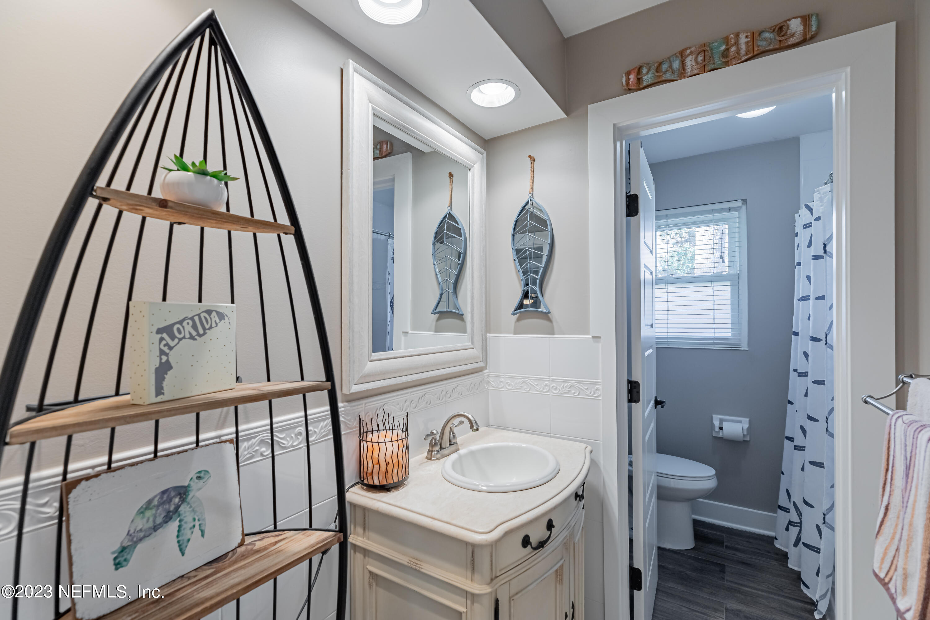 3467 Eunice Road Jacksonville, FL 32250 - Photo 56 of 83 a bathroom with a sink a toilet and a mirror