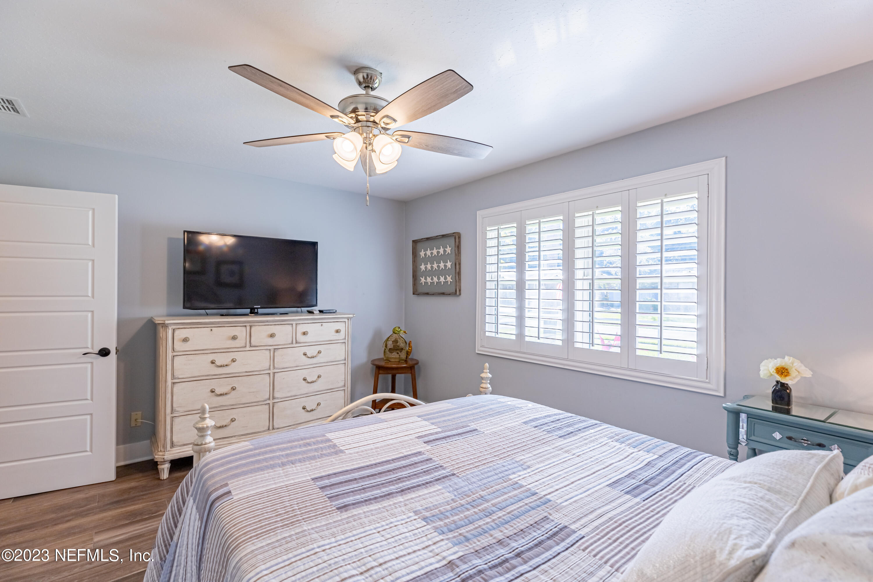 3467 Eunice Road Jacksonville, FL 32250 - Photo 57 of 83 a bedroom with a large bed and a flat screen tv