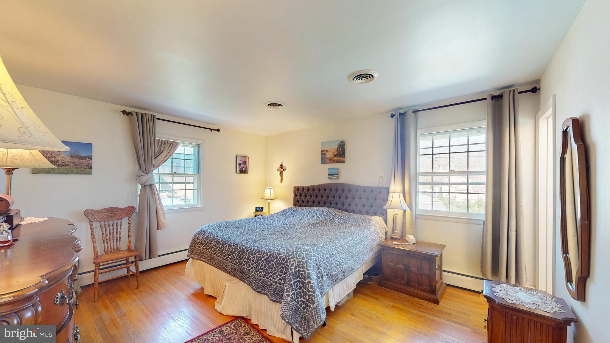9126 Dunloggin Road Ellicott City, MD 21042 - Photo 14 of 41 a spacious bedroom with a bed and wooden floor