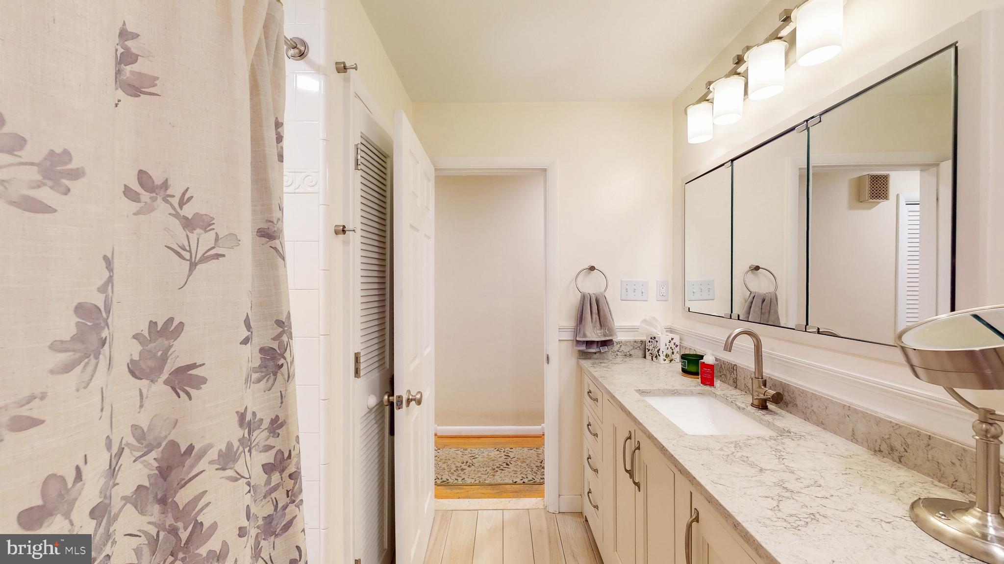 9126 Dunloggin Road Ellicott City, MD 21042 - Photo 24 of 41 a bathroom with a granite countertop sink and a mirror