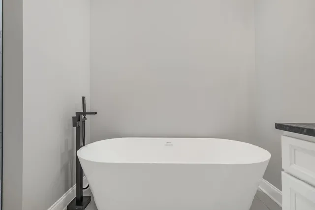 a white bath tub sitting in a bathroom