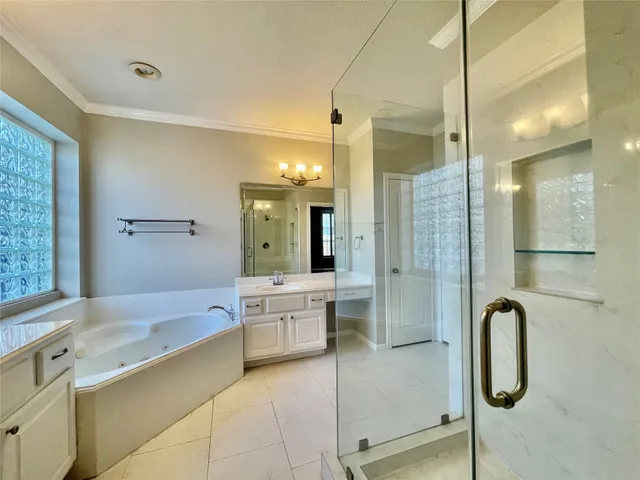 a bathroom with a tub sink shower and mirror