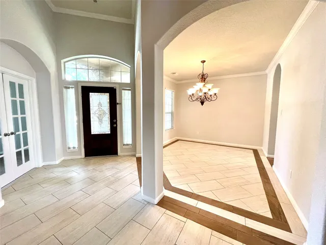 en view of an entryway with a chandelier