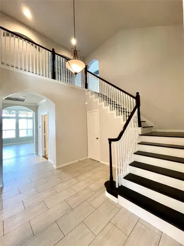 a view of staircase with white walls and a window