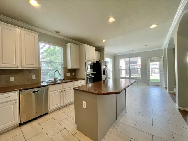 a kitchen with stainless steel appliances granite countertop a sink and cabinets