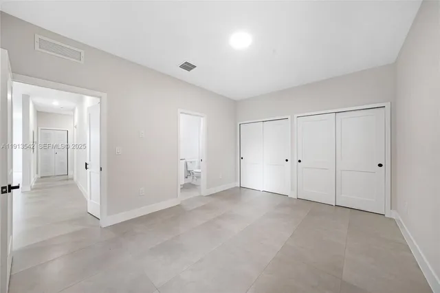 a bathroom with a granite countertop sink toilet and mirror