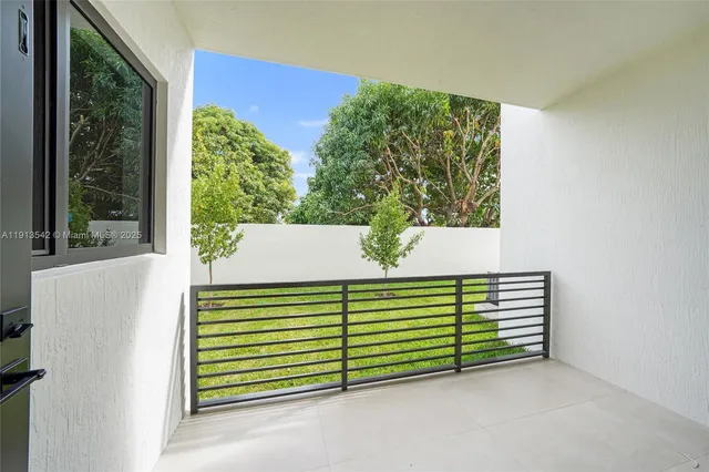 a house with green field in front of it
