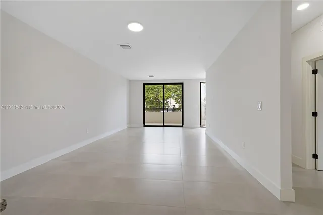 a kitchen with stainless steel appliances granite countertop a stove top oven a sink and white cabinets
