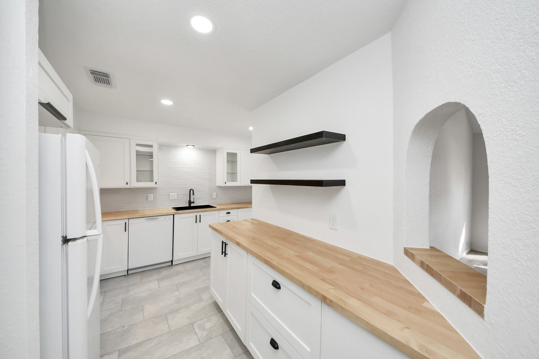 6601 Sands Point Drive, Unit 47 Houston, TX 77074 - Photo 14 of 46 a kitchen with white cabinets and refrigerator