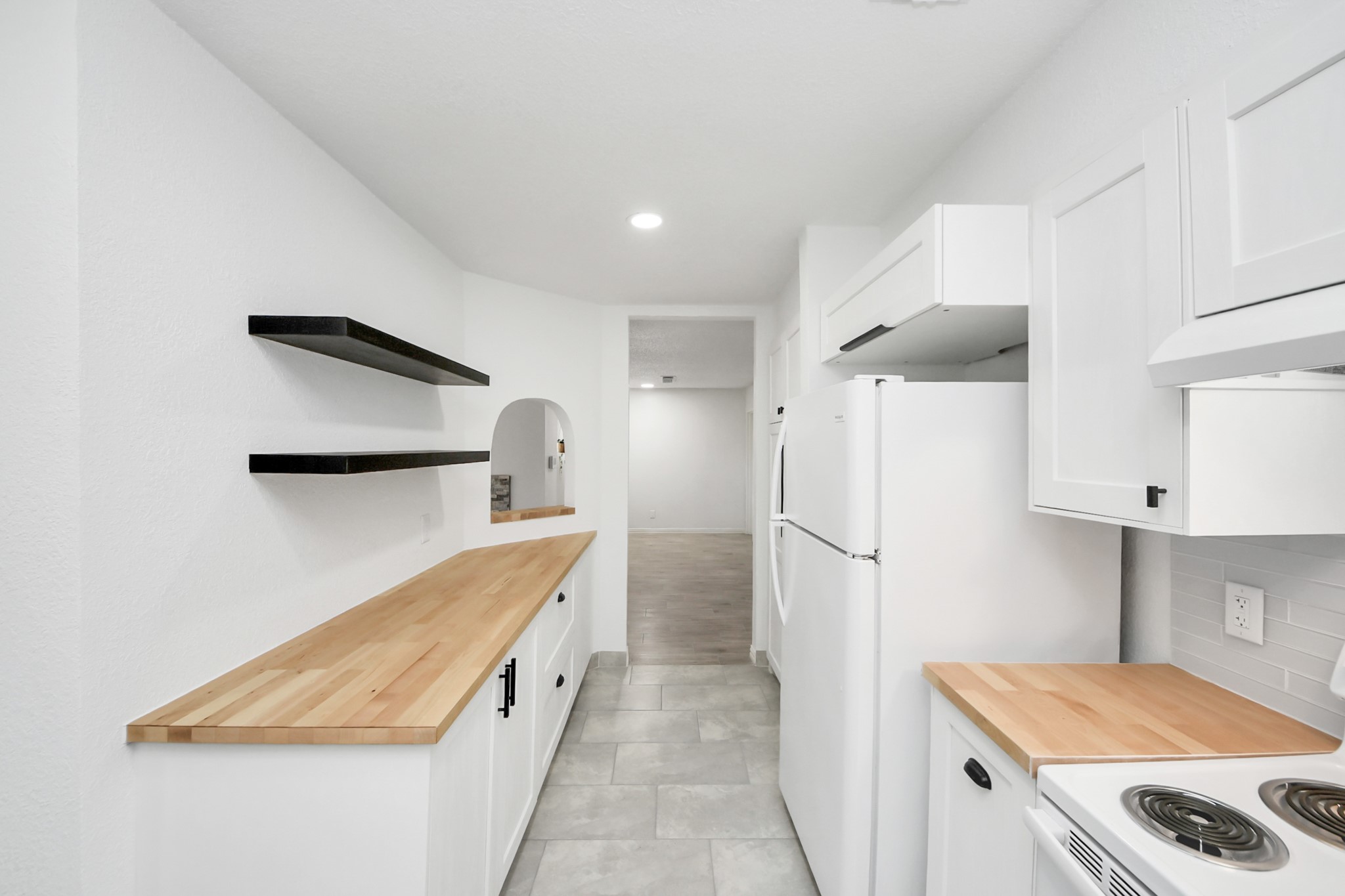 6601 Sands Point Drive, Unit 47 Houston, TX 77074 - Photo 16 of 46 a kitchen with white cabinets and refrigerator