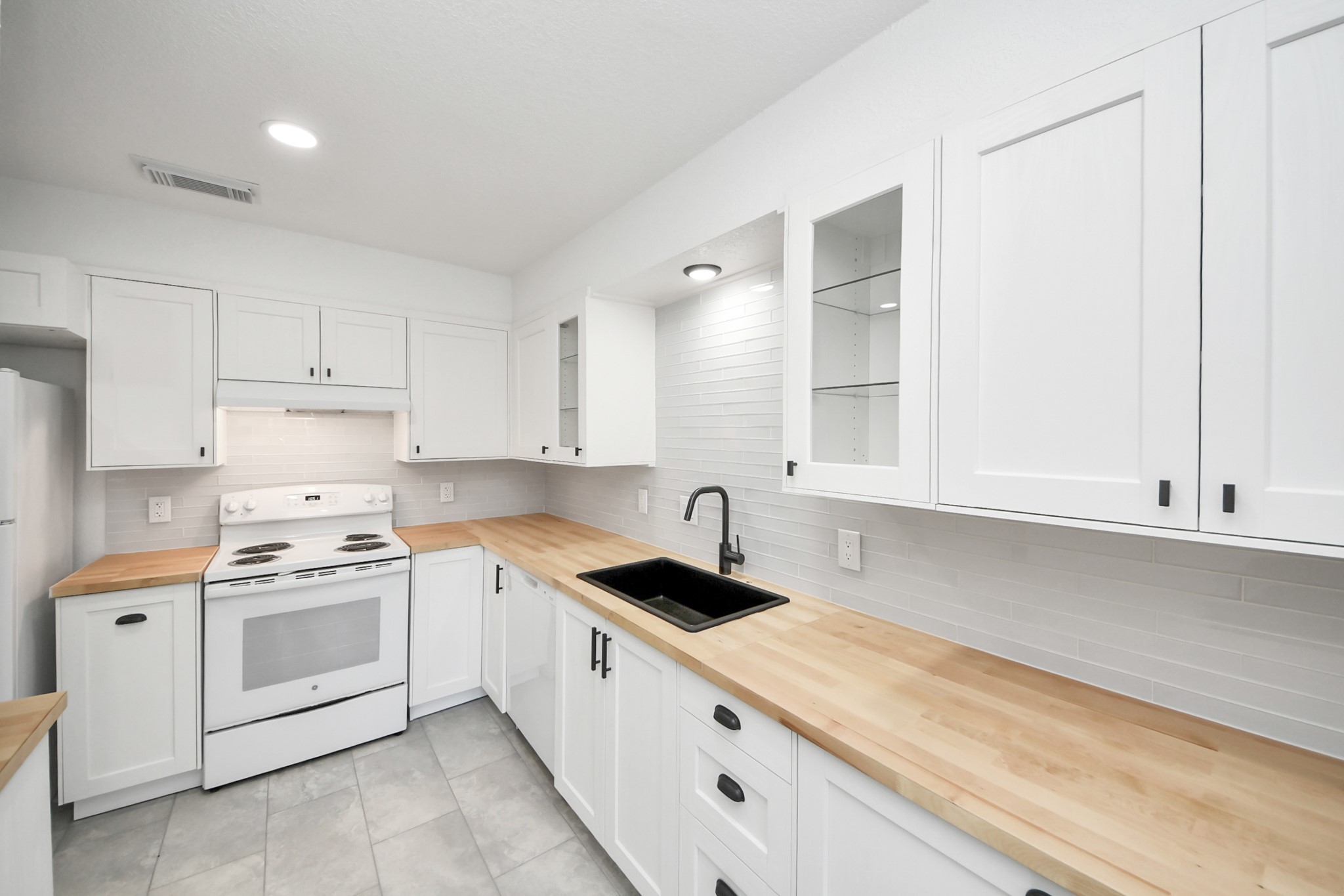 6601 Sands Point Drive, Unit 47 Houston, TX 77074 - Photo 20 of 46 a kitchen with white cabinets and white appliances