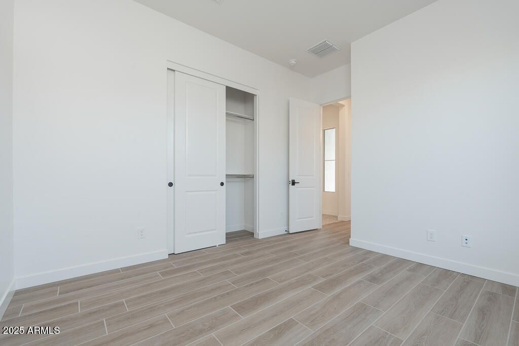 1244 East Prescott Street Gilbert, AZ 85298 - Photo 11 of 17 a view of an empty room with wooden floor