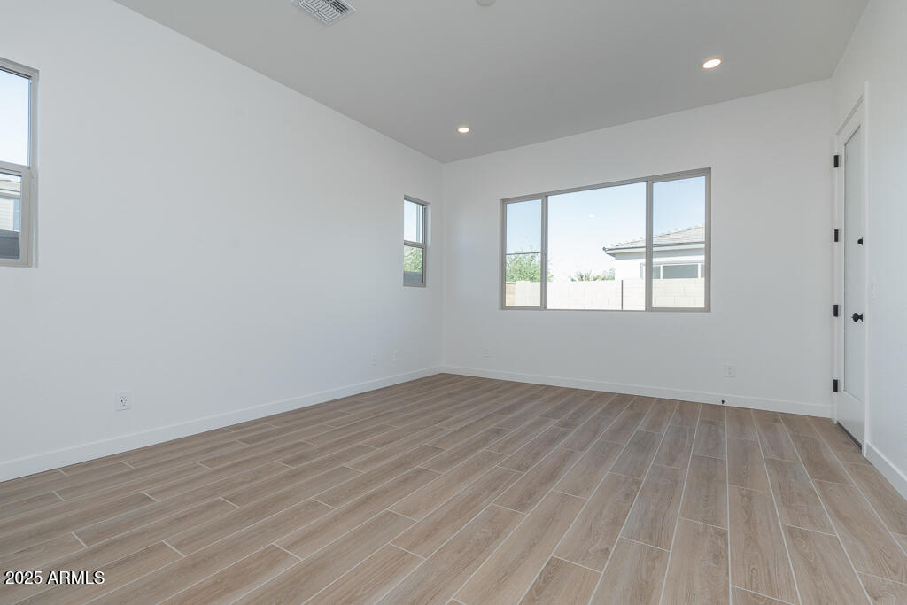 1244 East Prescott Street Gilbert, AZ 85298 - Photo 8 of 17 an empty room with wooden floor and windows