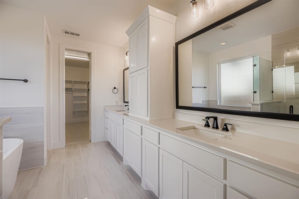 2650 Merrell Court Prosper, TX 75078 - Photo 12 of 28 a spacious bathroom with a double vanity sink a mirror and a shower