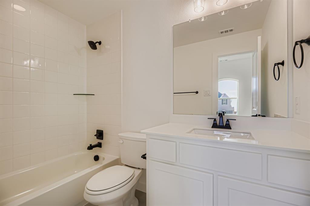 2650 Merrell Court Prosper, TX 75078 - Photo 19 of 28 a bathroom with a sink a toilet and a bathtub