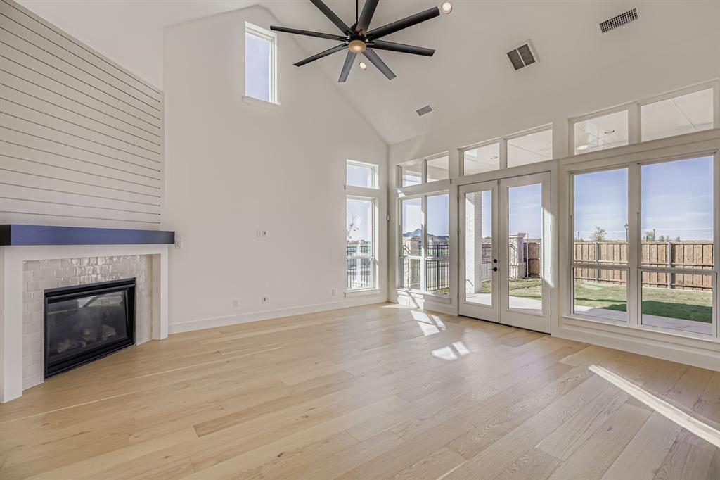 2650 Merrell Court Prosper, TX 75078 - Photo 5 of 28 a view of an empty room with windows and a fireplace
