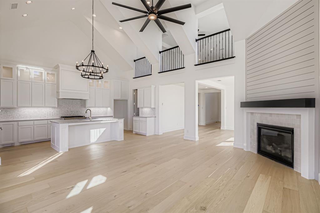 2650 Merrell Court Prosper, TX 75078 - Photo 27 of 28 a open kitchen view with fireplace and cabinets