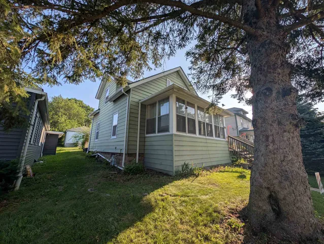 a front view of a house with a garden
