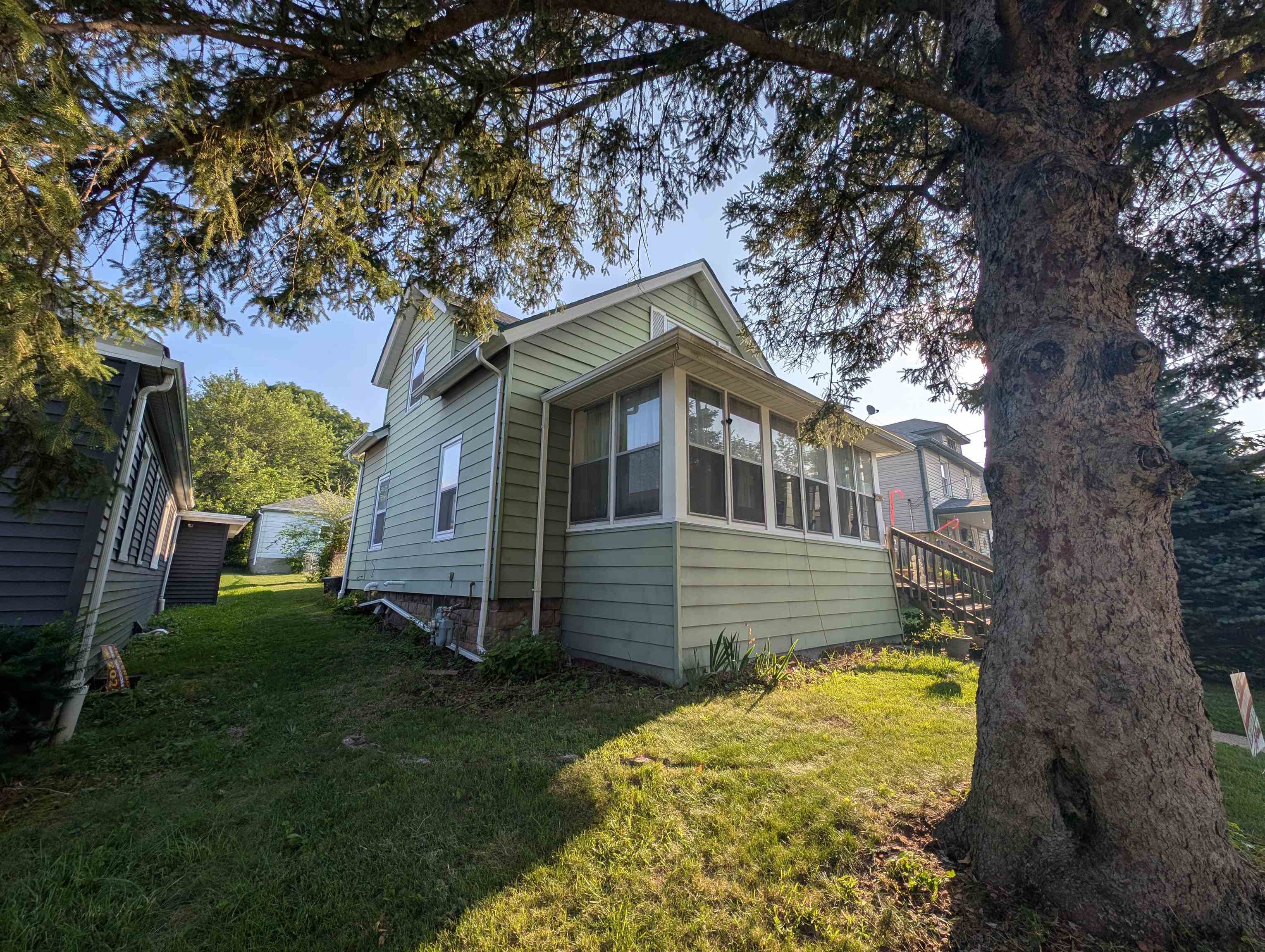 2208 13th Avenue Rockford, IL 61104 - Photo 2 of 5 a front view of a house with a garden